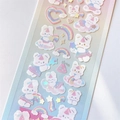 Detailed view of holographic stickers featuring cute white bears and pastel rainbow clouds - Rainbow Rabbit