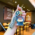 Detail of cute astronaut keychain with blue sequins, Sakura strap, and golden bell charm - Sakura Rope Luminous Bubble Beads Orange Figure Style / Black