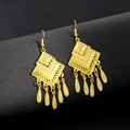 Detail of bohemian gold tassel earrings featuring leaf pendants on black leather background - E5765-6 Gold Hollow Geometric Tassel