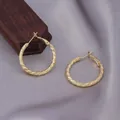 Golden twisted hoop earrings with elegant spiral texture on a grey satin background - Twisted Woven Texture Hoop / E-045---Gold