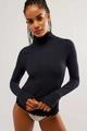 Detailed close-up of dark blue waffle knit top showing thumbhole sleeve design and texture - Black