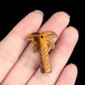 Tiger eye palm tree pendant with golden brown chatoyancy held in hand for jewelry DIY - Tiger's Eye