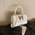 Creamy white bow crossbody handbag for women with silver metal buckle and top handle - White