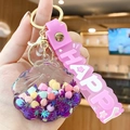 Llavero de concha rosa con purpurina y colgante de pulsera HAPPY de silicona - Morado