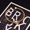 Handmade gold plated open bangle featuring three white natural freshwater pearls - Gold Single Pearl Woven Style