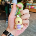 Capybara plush keychain in yellow with green hat and lobster clasp for bags - Light-up Tennis Capybara - Green