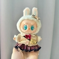 Labubu doll in beige knit vest, wine red plaid skirt, and green bunny hat with gold bag - Red Plaid Jk Crossbody Bag Five-piece Set / First And Second Generation Keychains Are Compatible With La Cloth Dolls. Dolls Not Included.