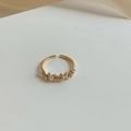 Vintage style gold adjustable ring with alternating bow designs and pearls on white cloth - Gold Pearl Bow Ring (J2941)