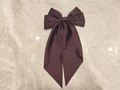 Elegant deep purple satin bow hair clip with long streamers on marble surface - Deep purple