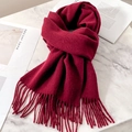 Elegant deep red wool scarf featuring decorative fringes on a marble surface - Ancorra Red