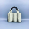 Close-up of handmade beaded square handbag with retro black and white polka dot pattern - Black