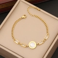 Detail of gold Cuban chain bracelet with Roman numeral disc and emerald-cut cubic zirconia - White Roman Numeral Bracelet