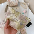 Macro shot of floral jacquard texture and 'simple wish' label on mini storage bag - Gold Thread Pink Flower