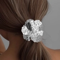 Silver flower hair tie with hammered texture and center pearl on a ponytail - Silver