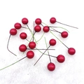 Close-up of bright red artificial berries with wire stems on white plush background - 15mm / Red