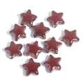 Detailed view of red ceramic star-shaped beads with vintage speckled glazed texture - Diameter 14mm / Dark Red