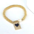 Vista macro del bracciale a sfere dorate con perla barocca e ciondolo cuore blu - Ciondolo Cuore Blu