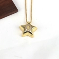 Macro shot of gold star pendant with zircon-inlaid letter O on a fine snake chain - Letter O
