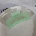 Matte mint green square hollow hair claw clip with a frosted finish on a white plate - Square Matte Cyan