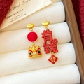 Detailed macro view of asymmetric Chinese New Year lion dance earrings on a white jewelry box - 12# Silver Needle - Flocked Rich Lion Asymmetric
