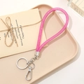 Pink glitter rope keychain with silver lobster clasp on a beige tray decorative setting - Rose Red