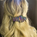 Close-up of a bohemian crystal spring hair clip worn on long wavy hair for party styling - Electroplated Rainbow
