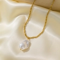 Baroque pearl pendant on gold twisted chain necklace set against cream satin - [H365] Heteromorphic Pearl Gold
