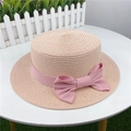Detailed texture of pink straw sun hat with a striped bow ribbon on a white table - M (56-58cm) Adjustable / Light Pink