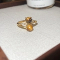 Macro shot of gold-plated ring featuring tiger eye stones and cubic zirconia inlay - Double Tiger's Eye Bead Style (6015659468497) / Gold Brown