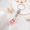 Portachiavi nautico con bottiglia di glitter rosa e ciondolo a forma di conchiglia in metallo - Rosa