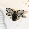 Exquisite gold bee brooch featuring a large black teardrop stone and zircon wings - Black