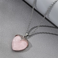Close-up of heart-shaped pink crystal pendant with elegant silver rope chain - Heart Rose Quartz