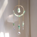 Detailed suncatcher with green stones and crystal prism producing rainbow light spots - Aventurine Jade