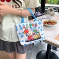 Cream canvas tote with blue cloud prints and happy cartoon motifs in a lifestyle setting - Coco Rabbit