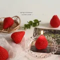 Red strawberry scented candle with realistic texture and cotton wick for home decor - Red Mini Strawberry Candles 4-Pack