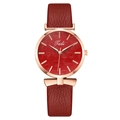 Detailed view of red quartz watch with rose gold bow charm and leaf pattern dial - Dark Red