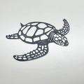 Artistic turtle wall decor in black metal with intricate cutouts for modern home interior - Black