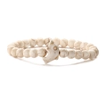 Macro detail of white turquoise beaded bracelet with a silver dolphin charm and marble texture - White Turquoise