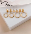 10-piece golden earring set featuring geometric studs and rings on a white display - Gold