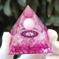 Pink crystal pyramid with Om symbol and amethyst stones held in gloved hands - Pink Cat Eye 3D / Small