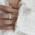 Detailed close-up of a 925 sterling silver multilayer wavy ring on a hand - Silver Ribbon Knot (JZ0832)