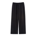 Close-up of black wide-leg trousers featuring elastic waistband and adjustable drawstring - Black Pants