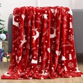 Detail of red Christmas flannel blanket with reindeer and snowflake patterns on a sofa - MT02-07 (Red Reindeer Snowflake)
