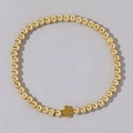 Bracciale elastico con perline dorate e un ciondolo a croce in metallo minimalista - Bracciale Singolo con Perline di Rame Dorato