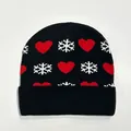 Close-up of black knit beanie featuring red heart and white snowflake festive patterns - Style 2 (Black Red Heart Snowflake)