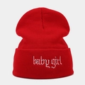 Detailed texture of red rib-knit beanie featuring white babygirl embroidery on the cuff - Red