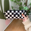 Close-up of corduroy pencil case with black and white checkerboard pattern and zipper - Black Check