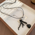 Detail of vintage double-layer necklace with black branch pendant and heart charm - Heart Branch Pendant (Black) / Black