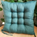 Thick square quilted dark green chair cushion with ties on a light wood table - [Square] Dark Green