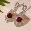 Macro detail of silver drop earrings featuring square red gemstone and pavé diamonds - Silver Pin - Red Rhinestone Geometric Drop Earrings